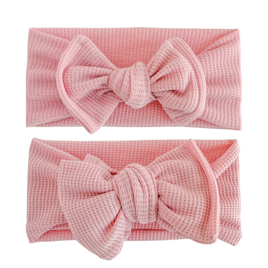 Baby girl headbands in top knot and oversized bow styles in dusty pink, made from waffle knit fabric
