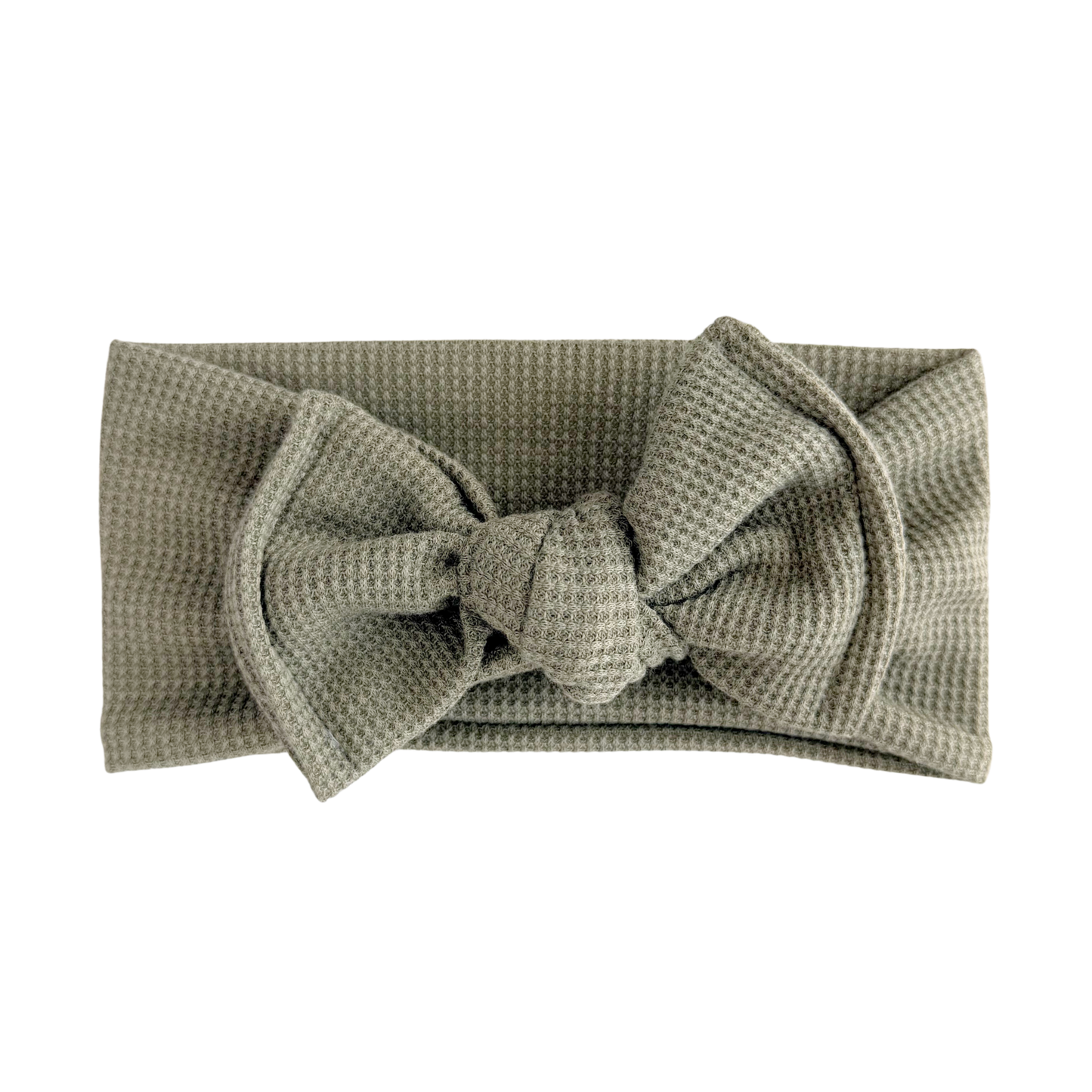 Green textured headband with a bow on a white background