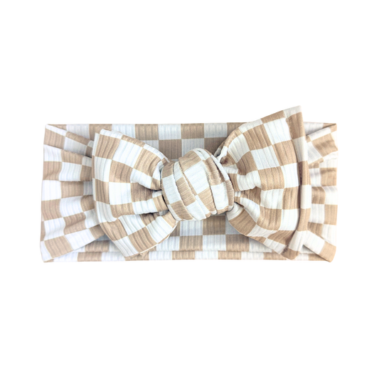 Checkered headband with a large bow on a white background