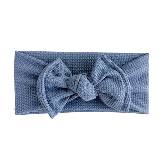 Dusty blue waffle top knot bow headband on a white background