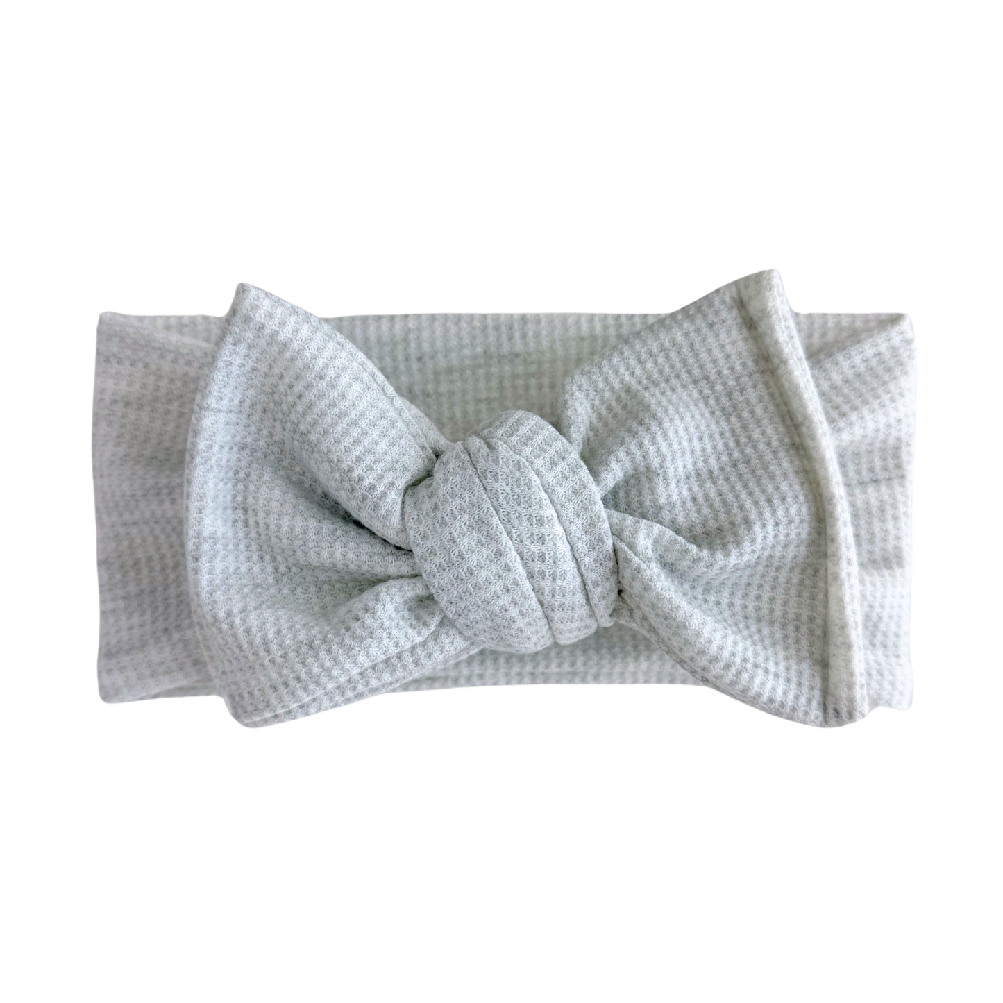 Light gray waffle oversized bow headband with a bow on a white background