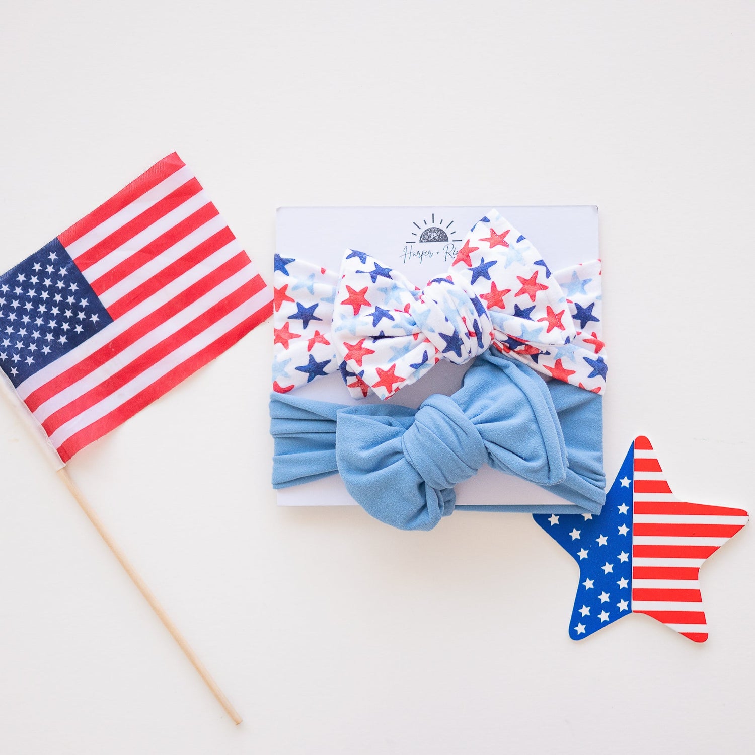 Green and grey baby bows laying flat with St. Patrick's Day decor