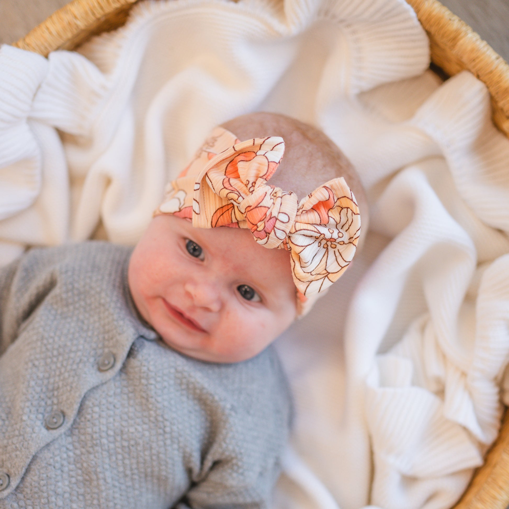Baby wearing a floral headband with a soft focus background