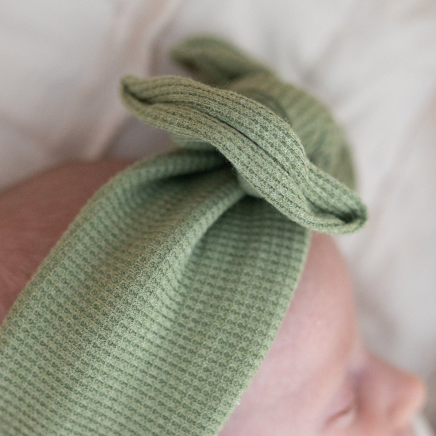 Close-up of a green waffle textured fabric.
