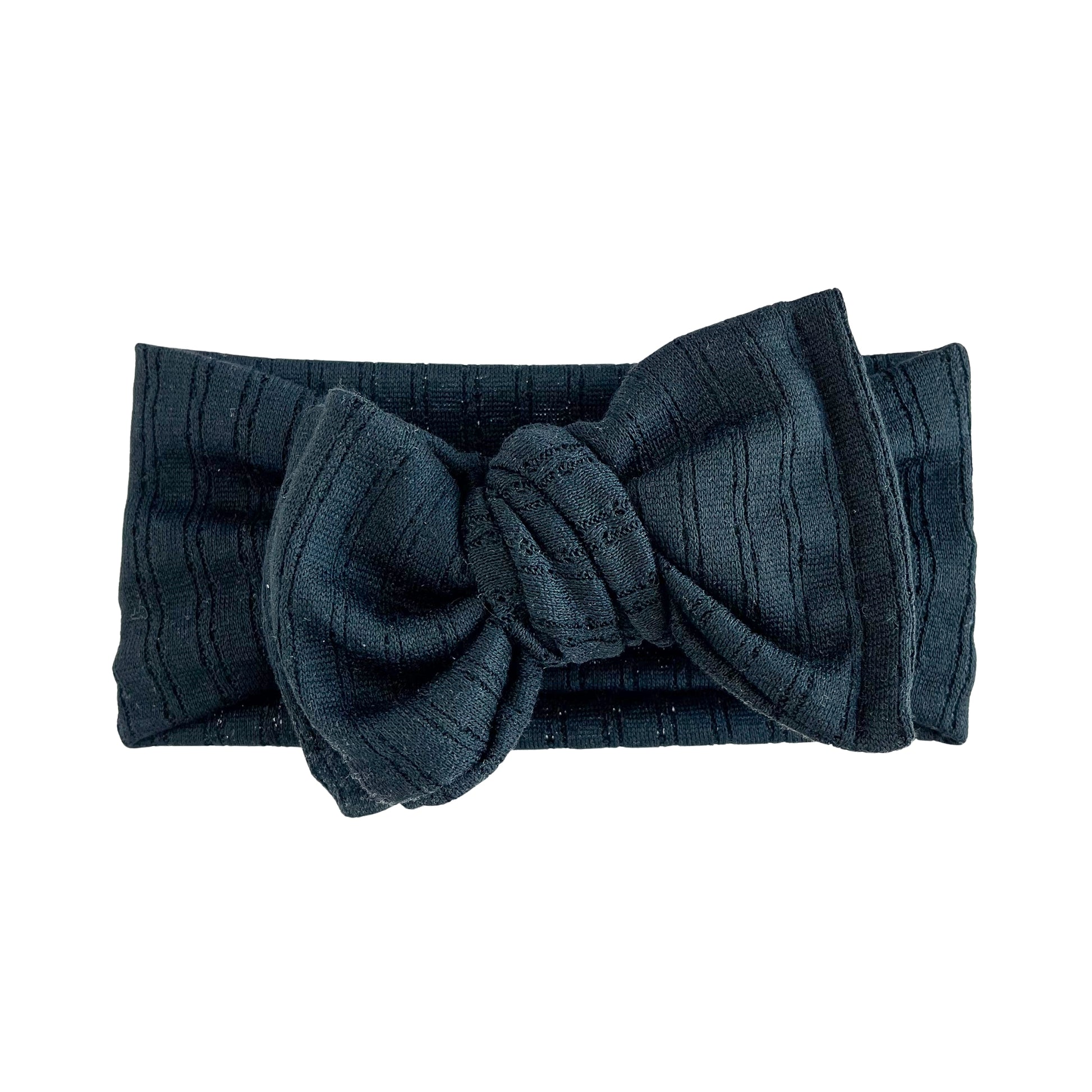 Oversized bow baby headband in black, crafted from pointelle knit fabric, displayed on a white background
