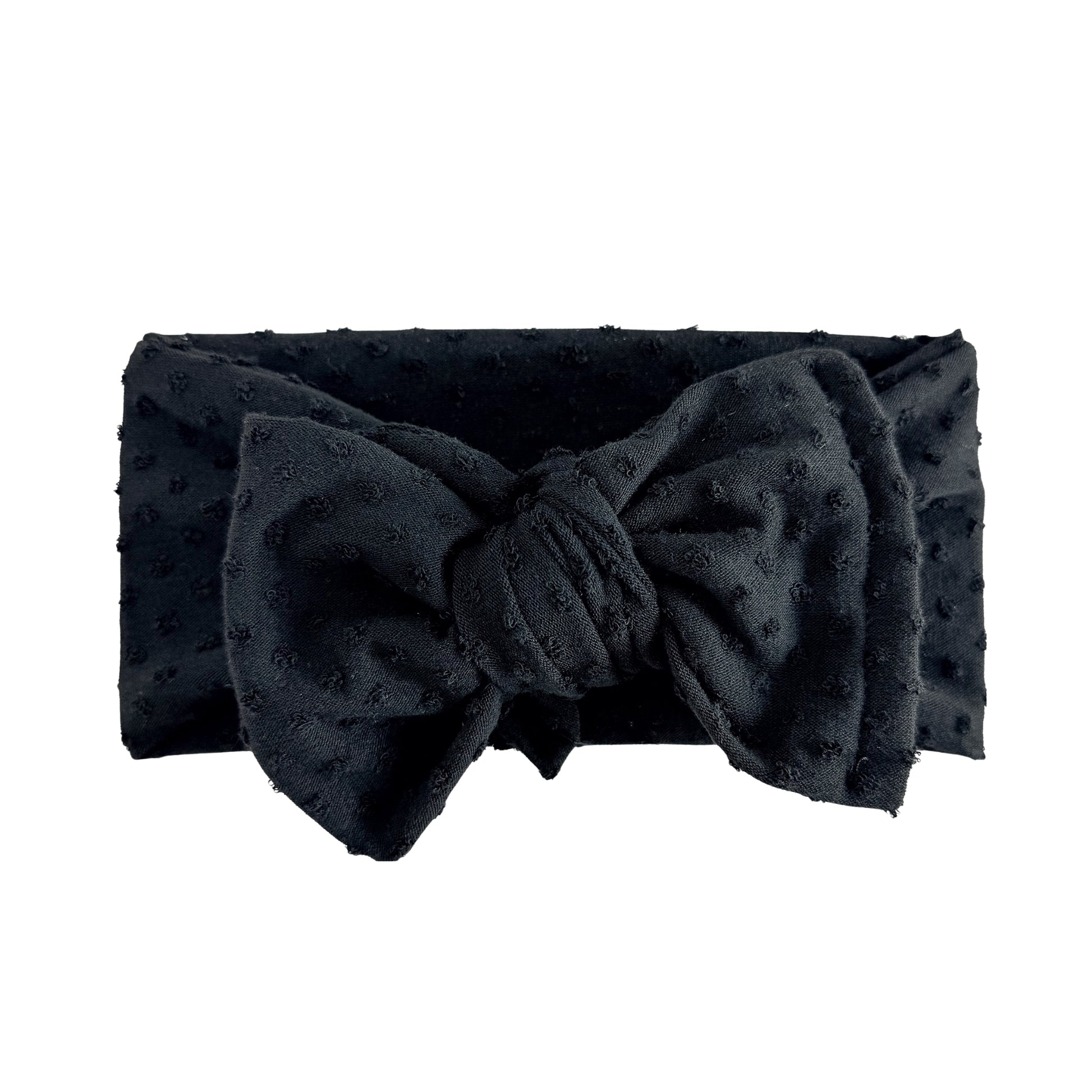 Oversized bow baby headband in black, crafted from Swiss dots knit fabric, displayed on a white background