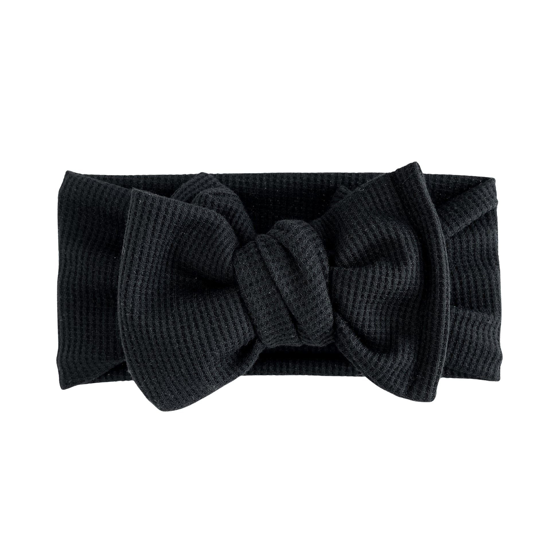 Oversized bow baby headband in black, crafted from waffle knit fabric, displayed on a white background