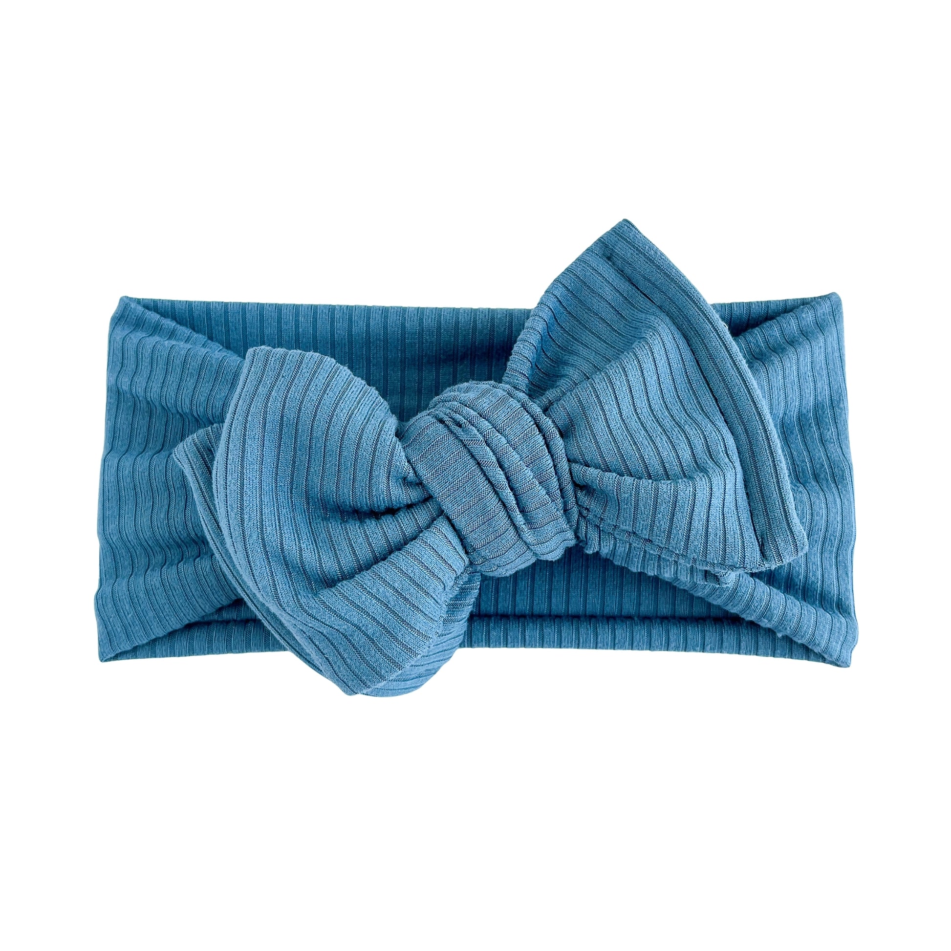 Oversized bow baby headband in blue, crafted from ribbed knit fabric, displayed on a white background