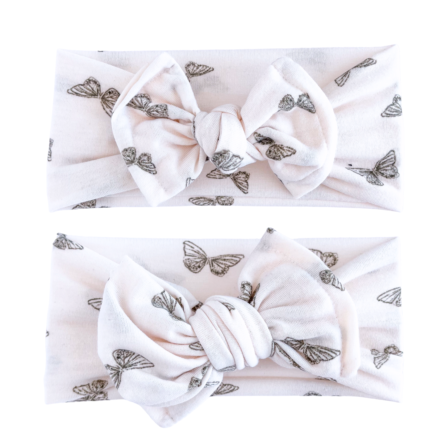 Two blush headbands with butterfly patterns on a white background