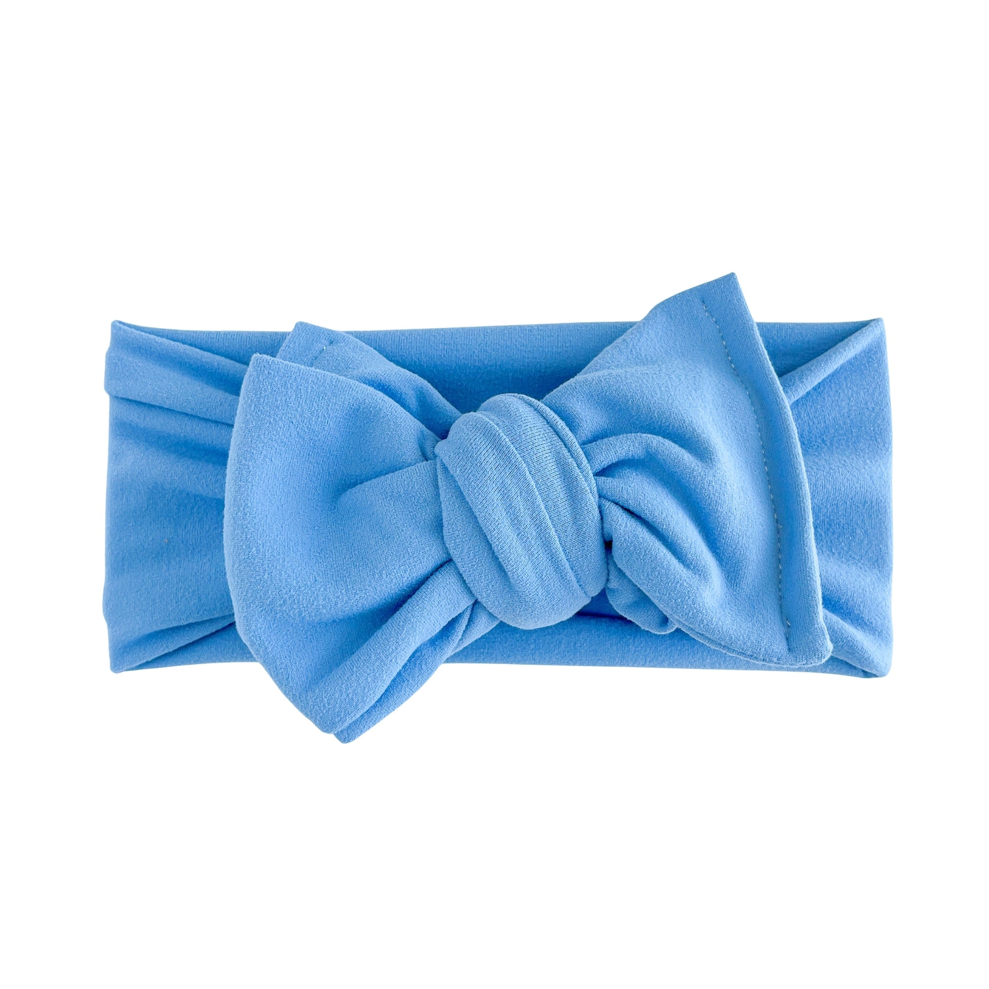 Oversized bow baby headband in bright blue, crafted from double brushed knit fabric, displayed on a white background