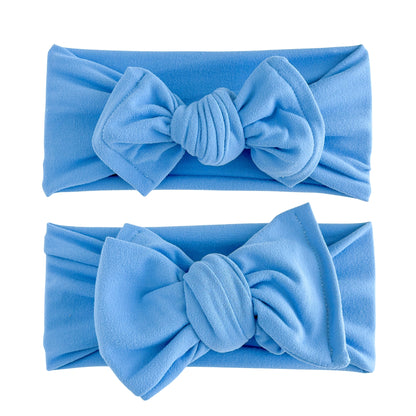 Baby girl headbands in top knot (top) and oversized bow (bottom) styles in bright blue, made from double brushed knit fabric