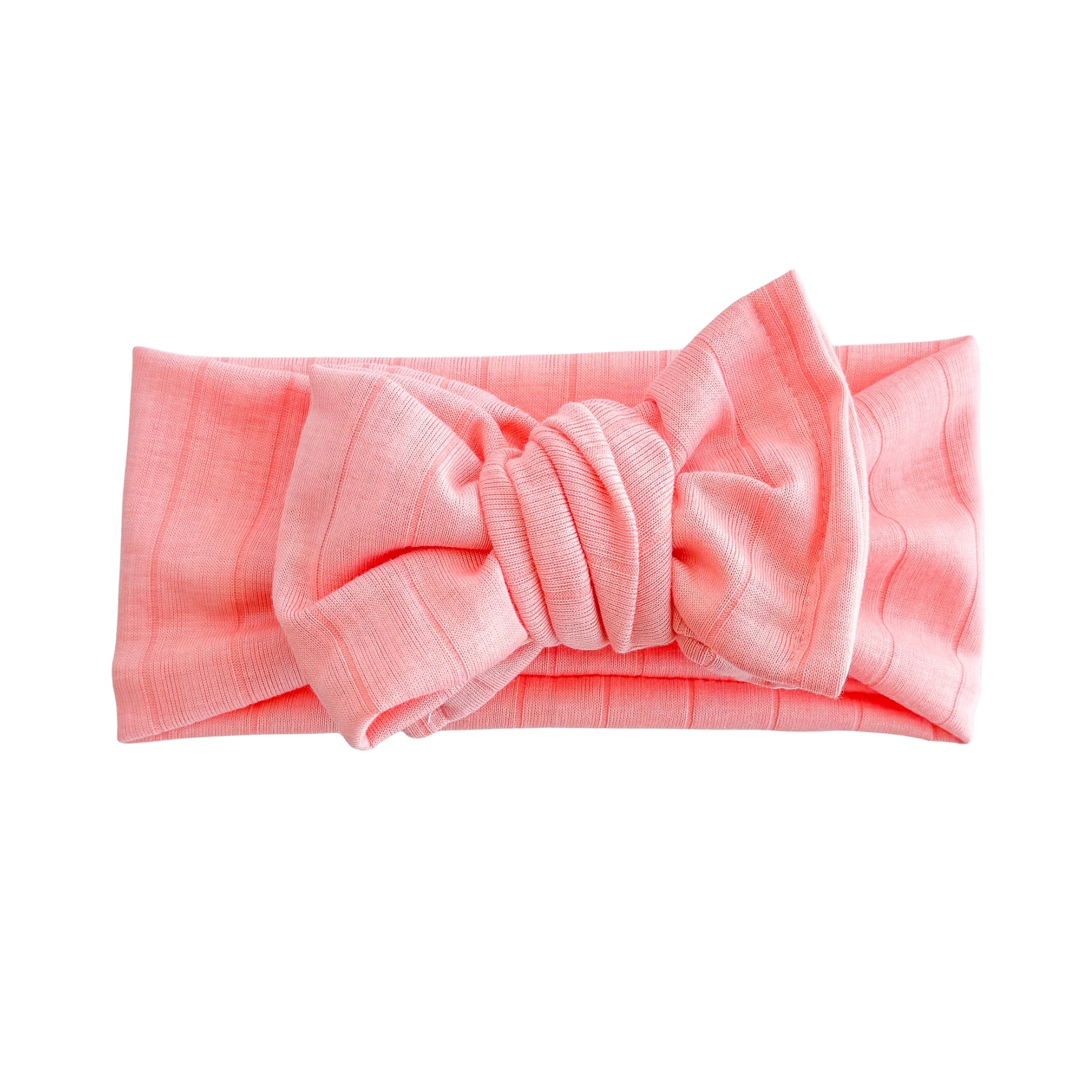 Top knot baby headband in bright coral, crafted from wide ribbed knit fabric, displayed on a white background