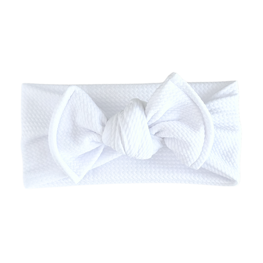 White textured headband with a bow on a white background