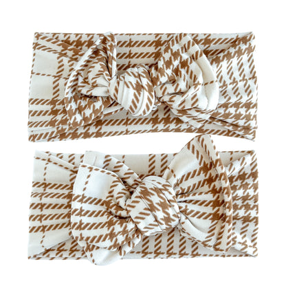 Baby girl headbands in top knot (top) and oversized bow (bottom) styles in cream with brown plaid print, made from double brushed knit fabric