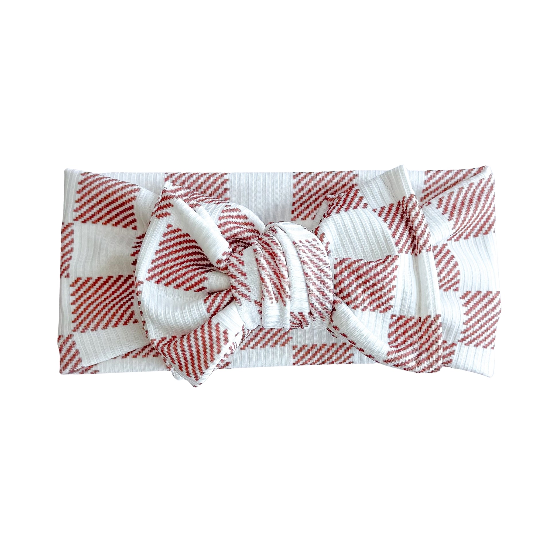 Oversized bow baby headband in brown and white checker print, crafted from ribbed knit fabric, displayed on a white background