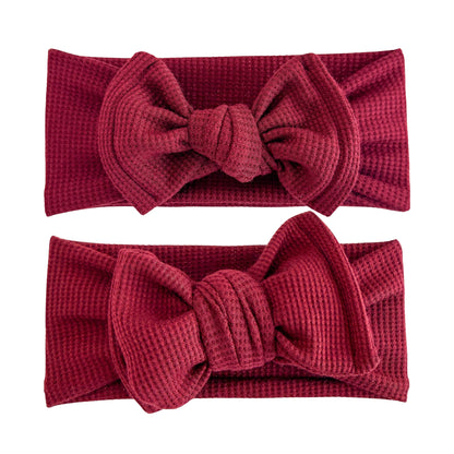 Baby girl headbands in top knot and oversized bow styles in burgundy, made from waffle knit fabric