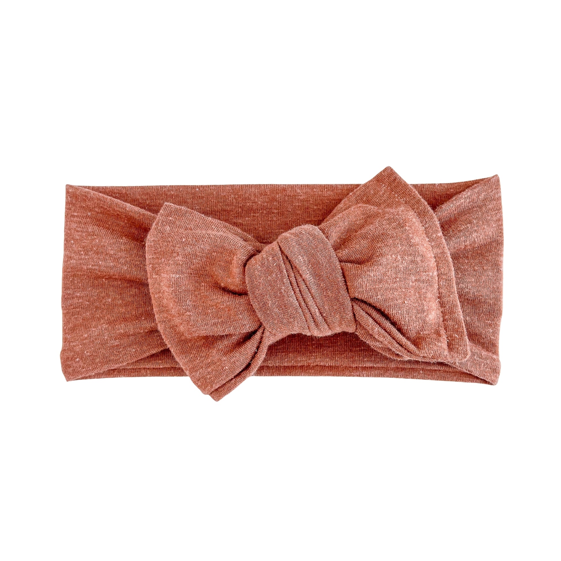 Oversized bow baby headband in burnt orange, crafted from jersey knit fabric, displayed on a white background
