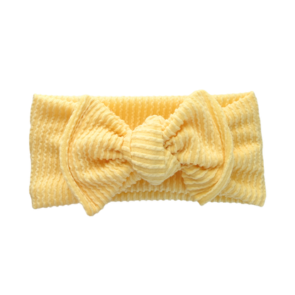 Yellow textured headband with a knot on a white background