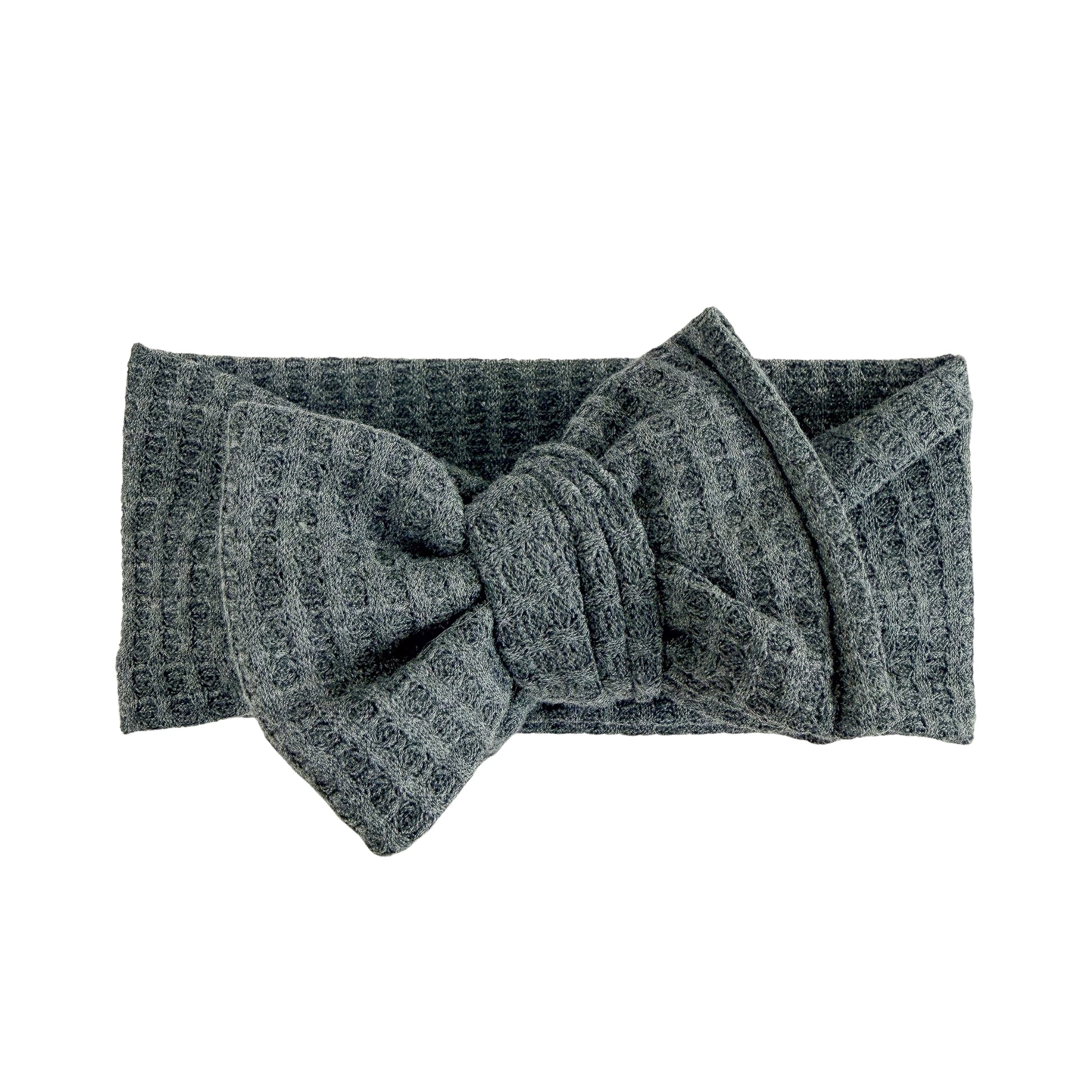 Oversized bow baby headband in charcoal gray, crafted from honeycomb waffle knit fabric, displayed on a white background