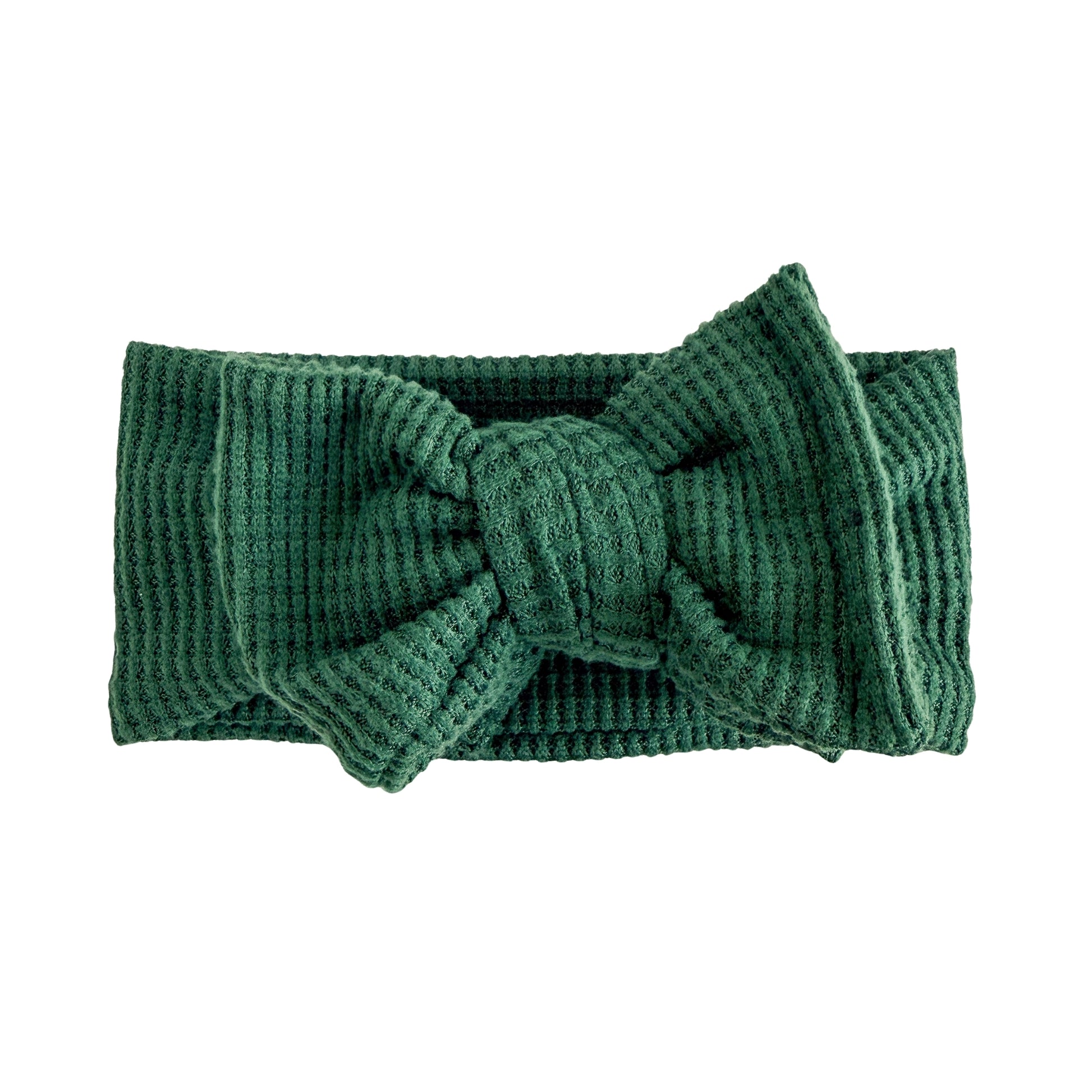 Oversized bow baby headband in dark green, crafted from brushed waffle knit fabric, displayed on a white background