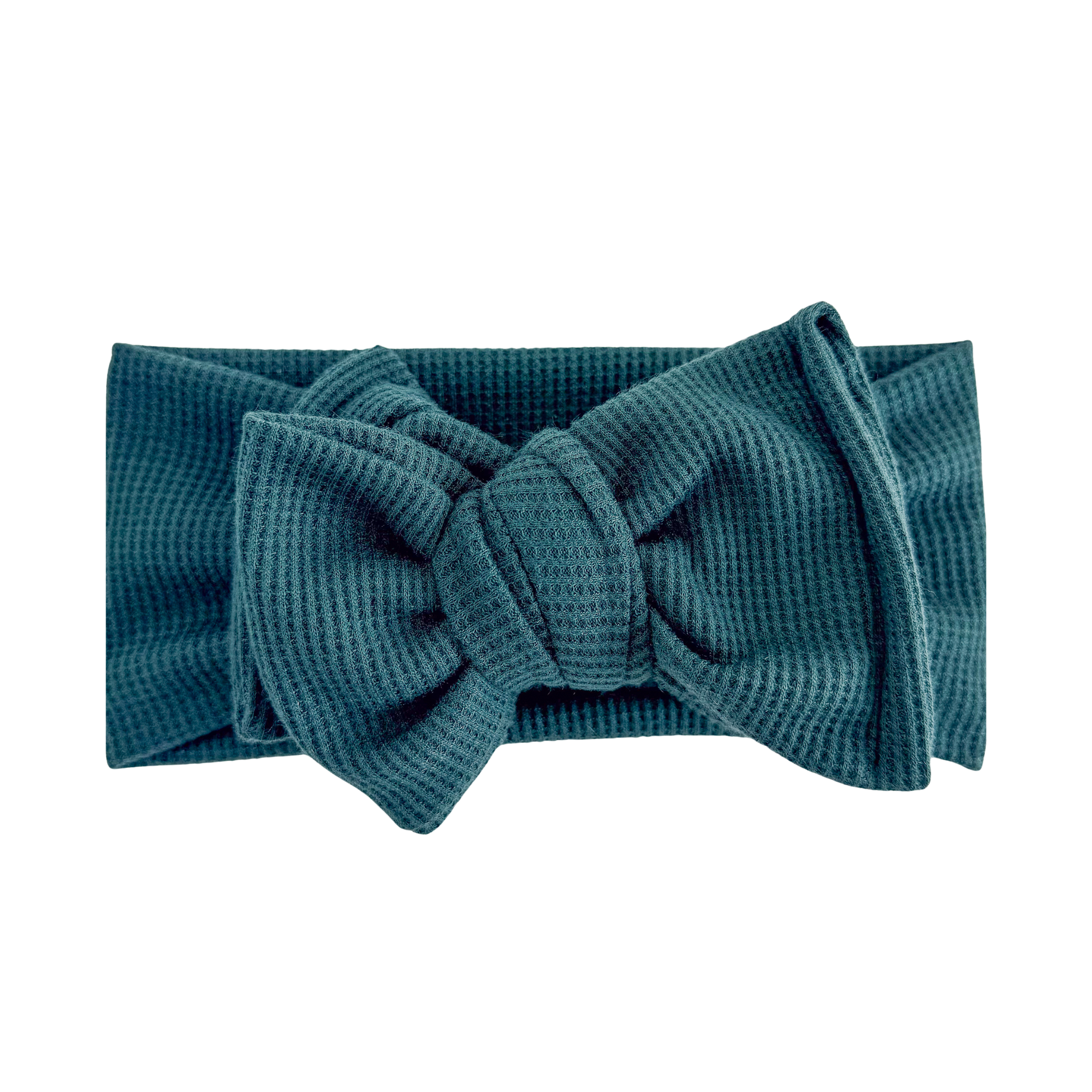 Oversized bow baby headband in dark green, crafted from waffle knit fabric, displayed on a white background