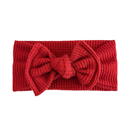 Top knot baby headband in dark red, crafted from brushed waffle knit fabric, displayed on a white background