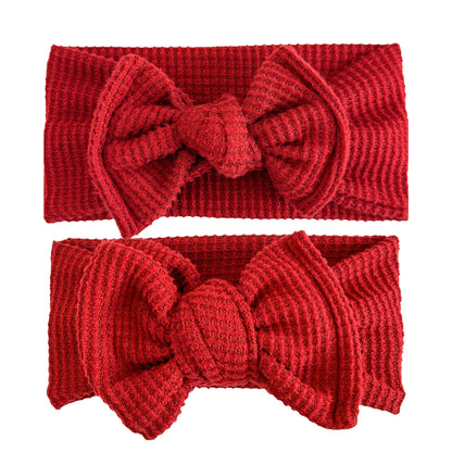 Baby girl headbands in top knot (top) and oversized bow (bottom) styles in dark red, made from brushed waffle knit fabric