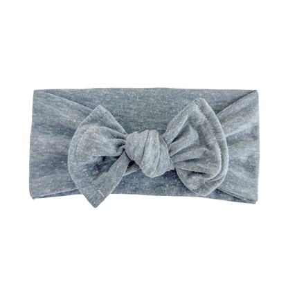 Top knot baby headband in grey blue, crafted from cotton jersey knit fabric, displayed on a white background