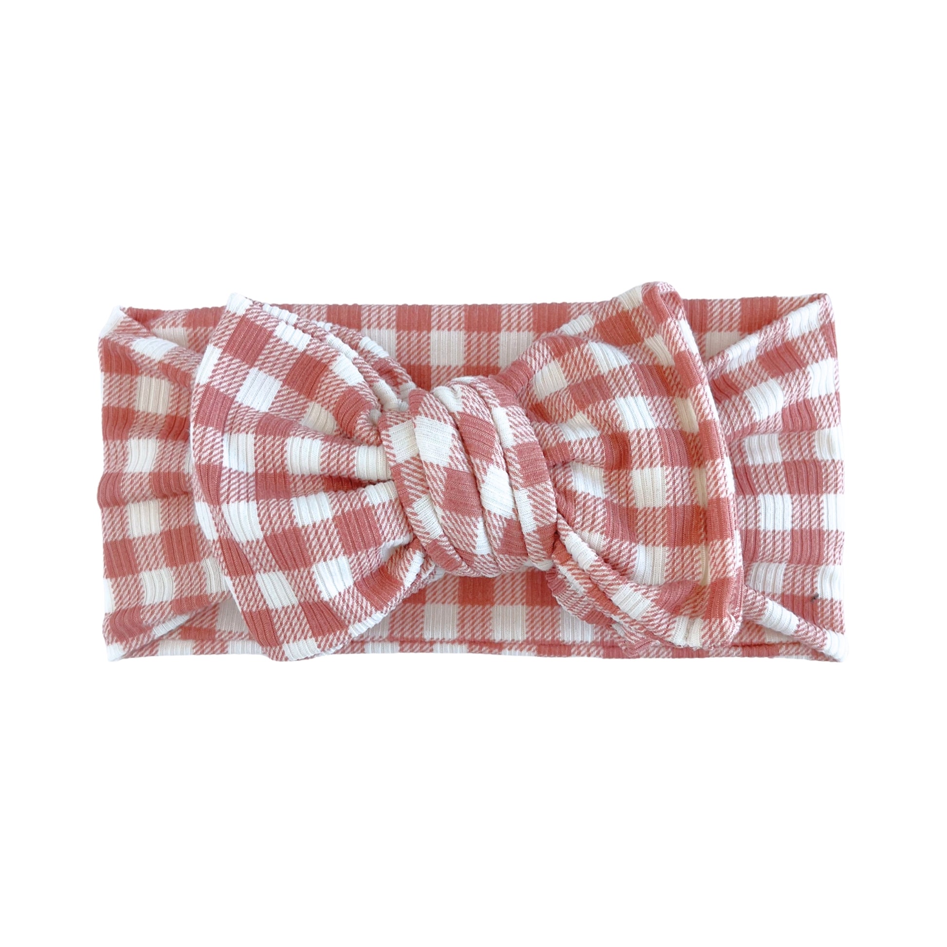 Oversized bow baby headband in dusty pink and white gingham print, crafted from ribbed knit fabric, displayed on a white background