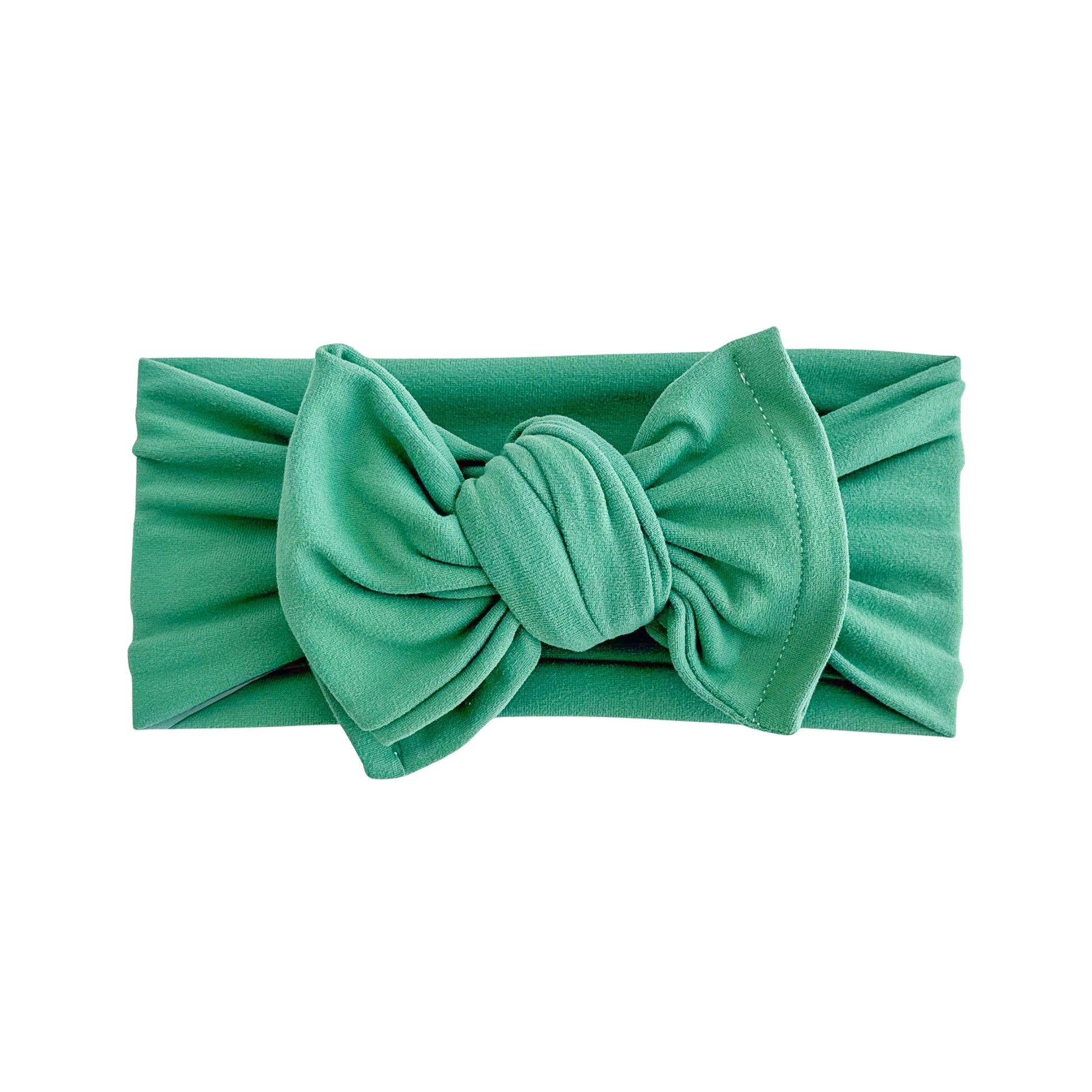 Oversized bow baby headband in green, crafted from double brushed knit fabric, displayed on a white background