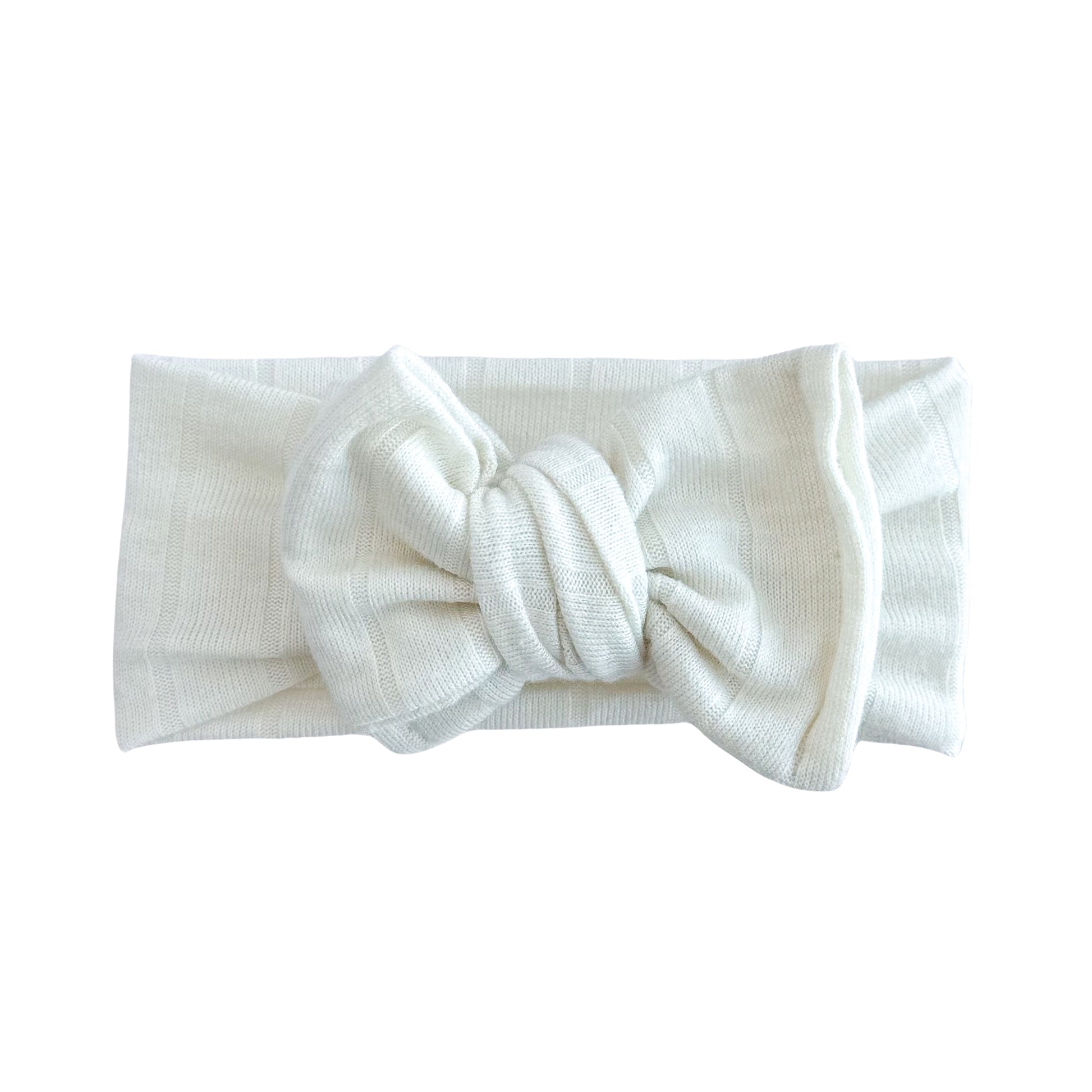 Oversized bow baby headband in ivory, crafted from lightweight sweater knit fabric, displayed on a white background