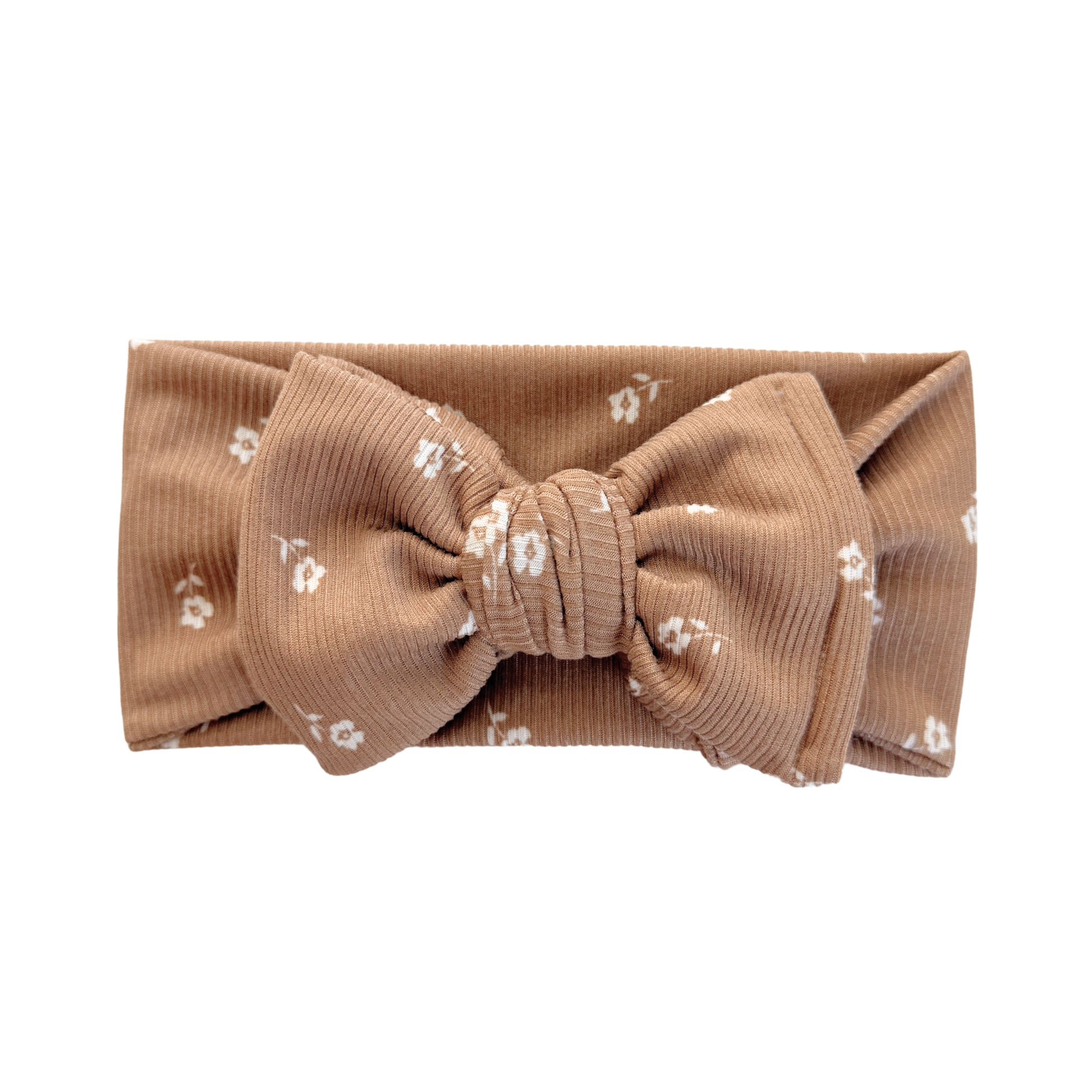 Brown headband with a large bow and small white floral pattern on a white background