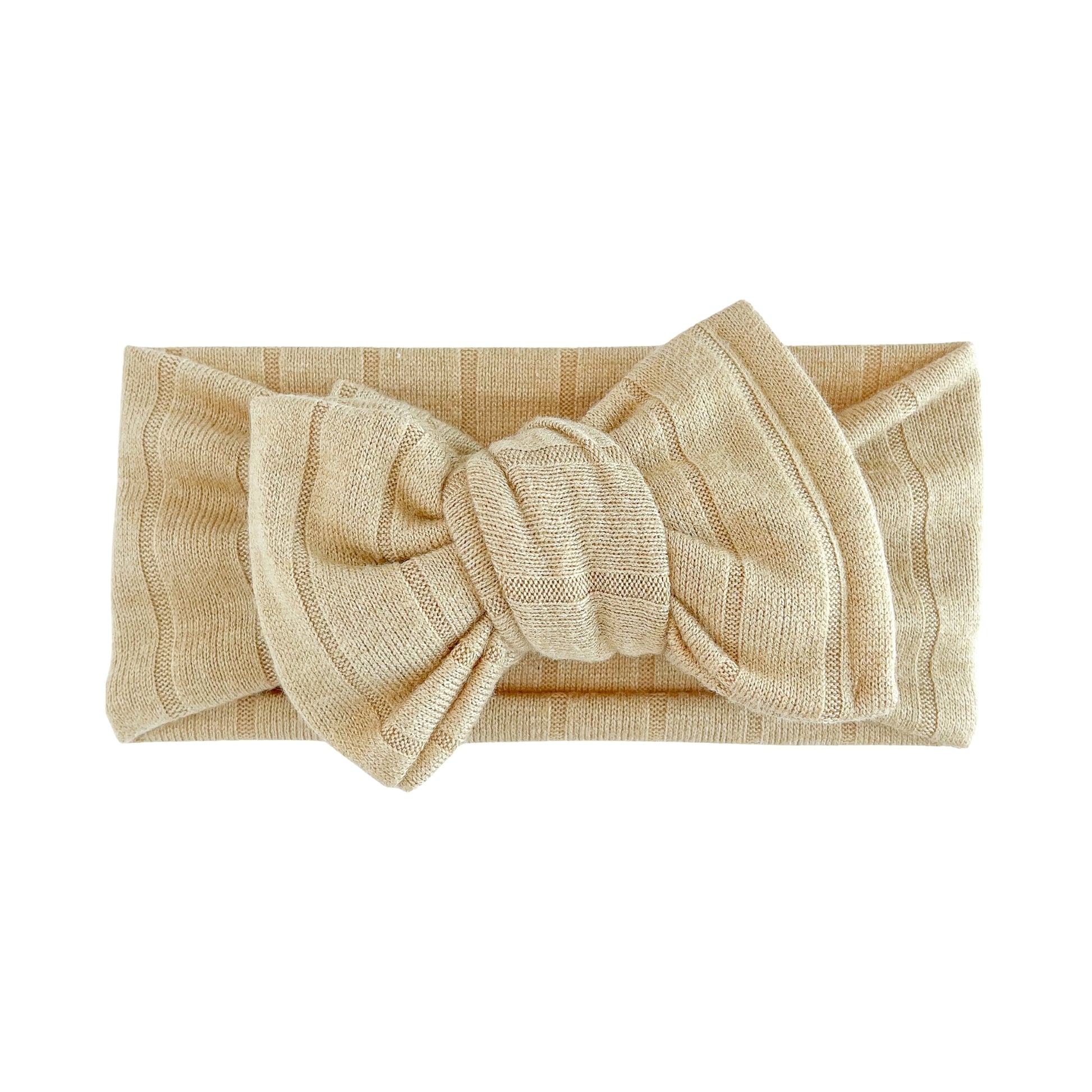 Oversized bow baby headband in light brown, crafted from light sweater ribbed knit fabric, displayed on a white background