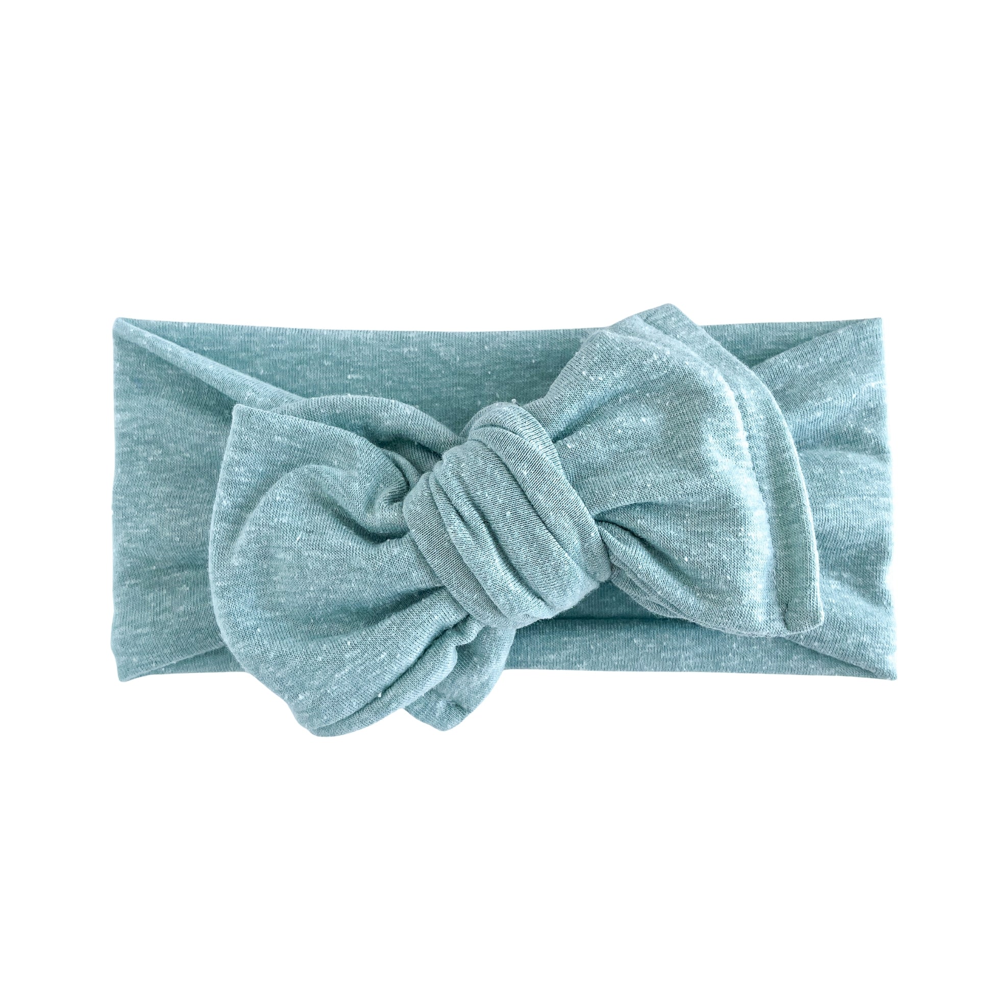 Oversized bow baby headband in light teal, crafted from cotton jersey knit fabric, displayed on a white background