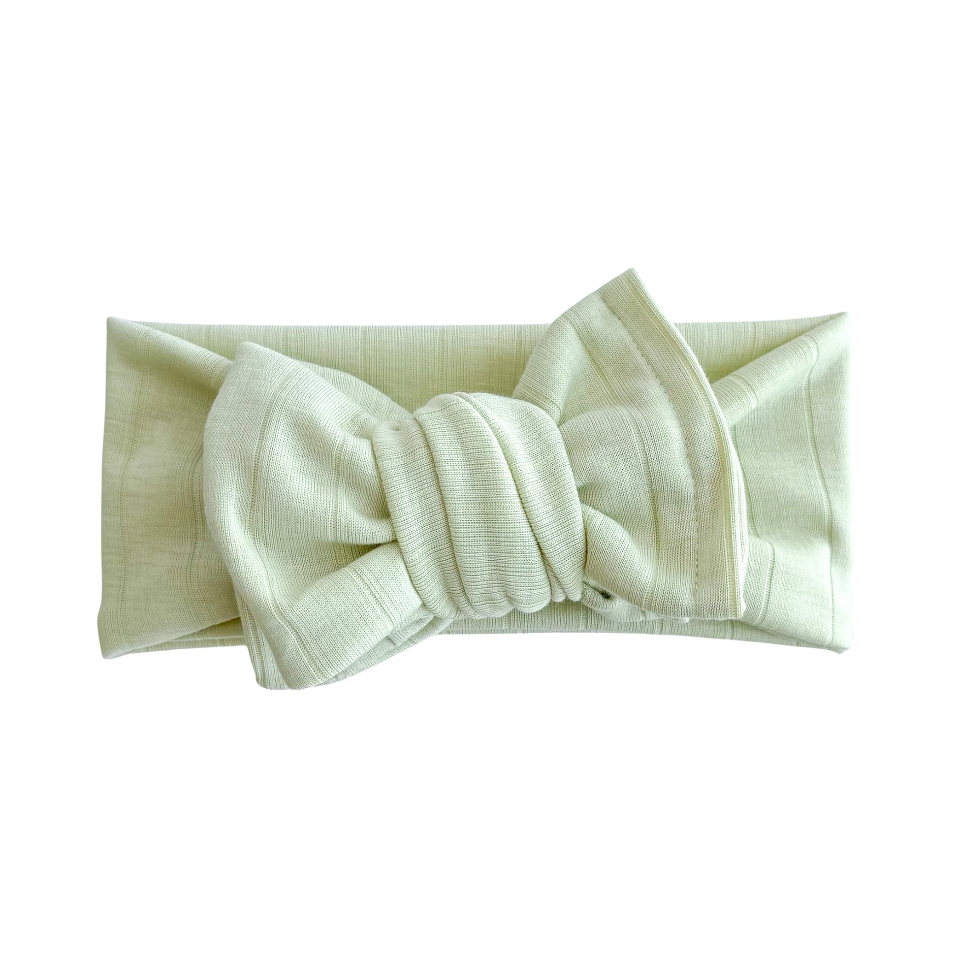 Top knot baby headband in lime green, crafted from wide ribbed knit fabric, displayed on a white background