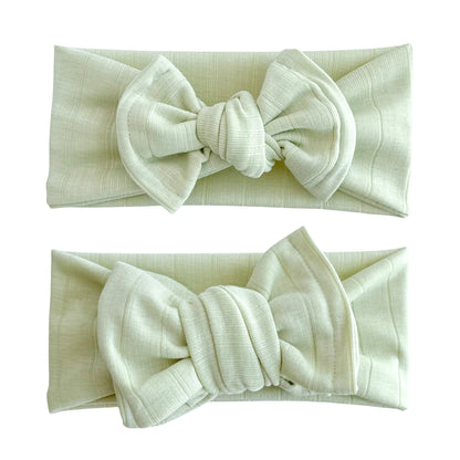 Baby girl headbands in top knot and oversized bow styles in lime green, made from wide ribbed knit fabric
