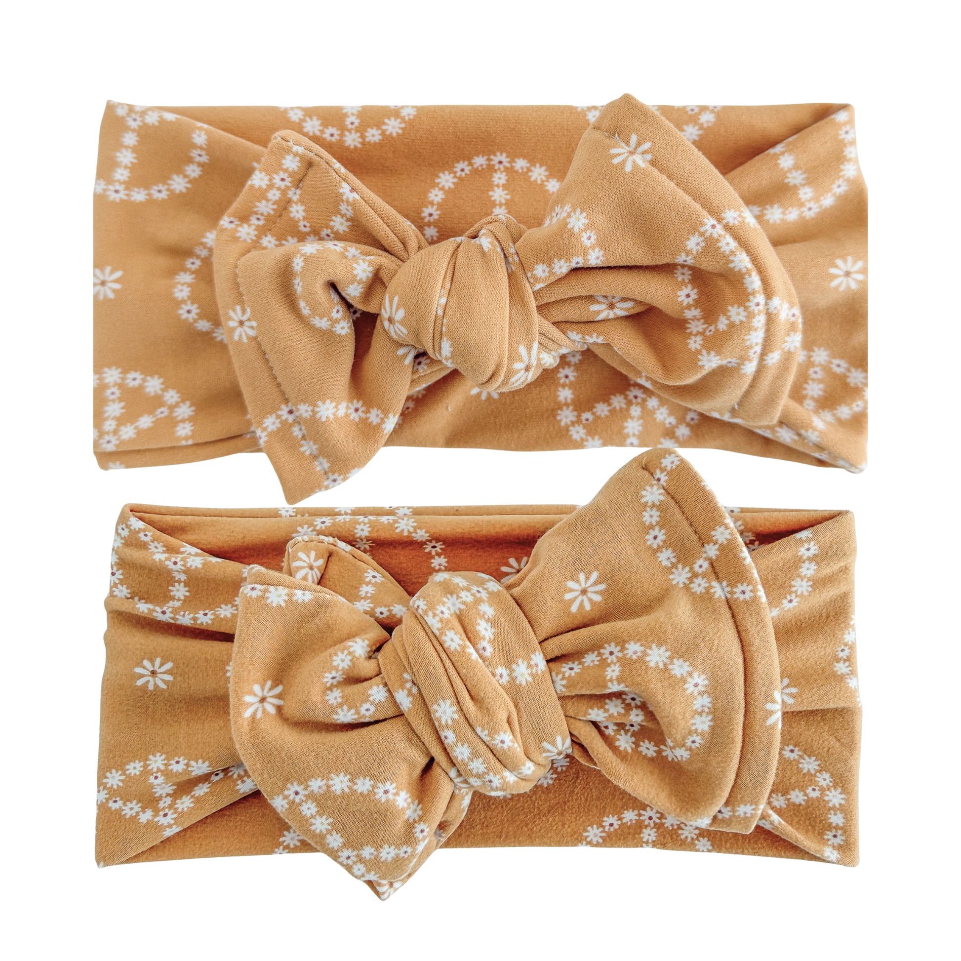Two yellow headbands with floral patterns on a white background
