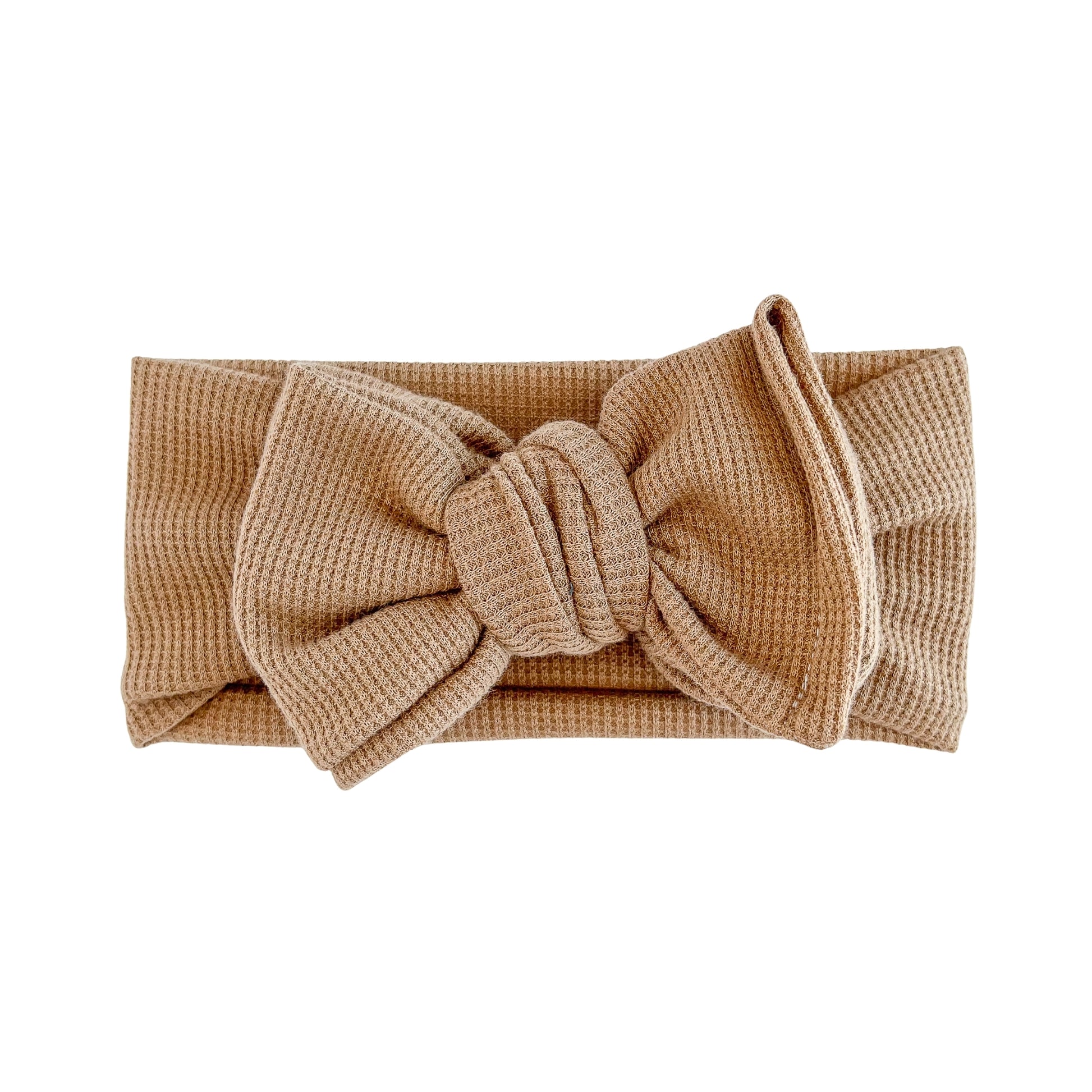 Oversized bow baby headband in mocha brown, crafted from waffle knit fabric, displayed on a white background