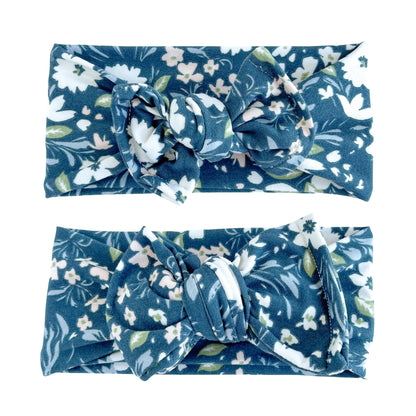 Baby girl headbands in top knot (top) and oversized bow (bottom) styles in navy flue floral print, made from double brushed knit fabric