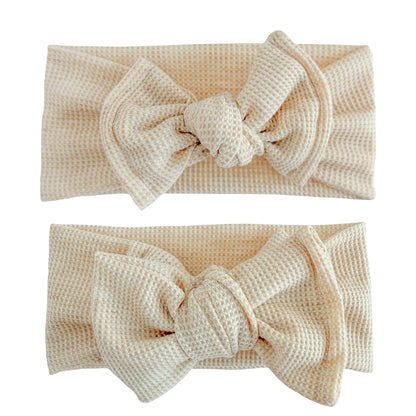 Baby girl headbands in top knot and oversized bow styles in oatmeal heather, made from waffle knit fabric