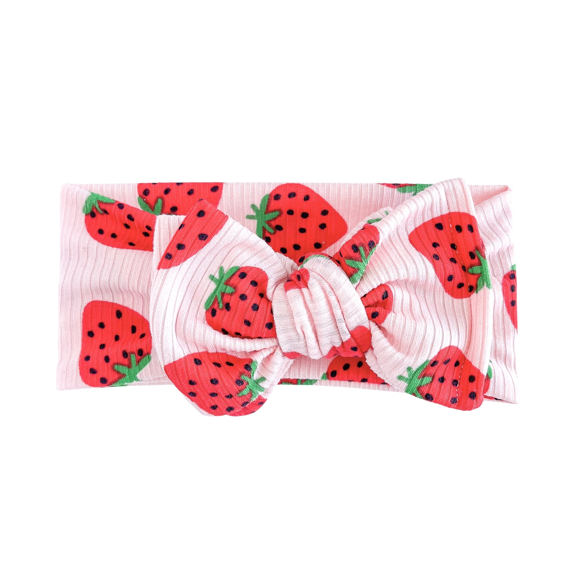 Oversized bow baby headband in light pink with red strawberry pattern, crafted from ribbed knit fabric, displayed on a white background