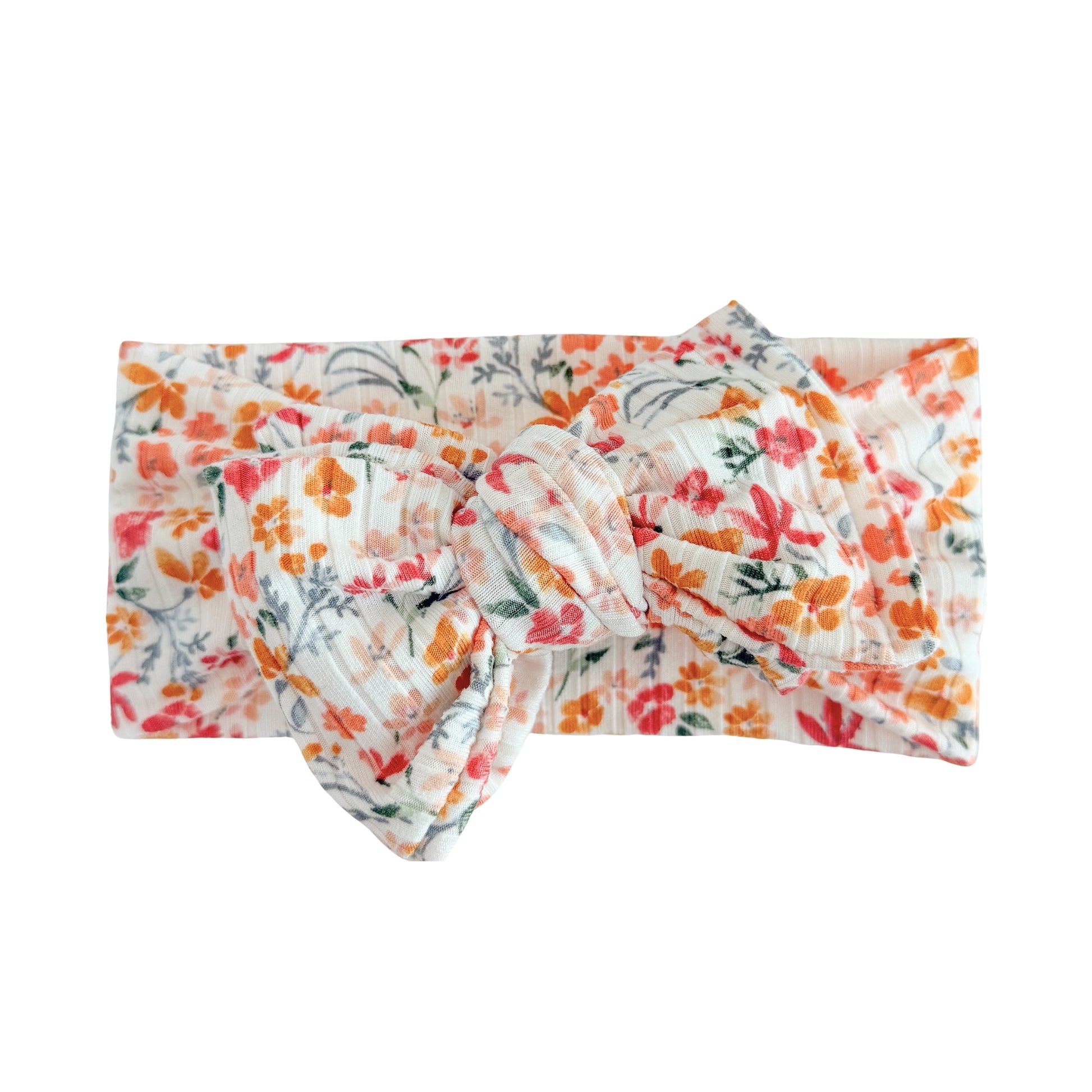 Oversized bow baby headband in pink floral print, crafted from ribbed knit fabric, displayed on a white background