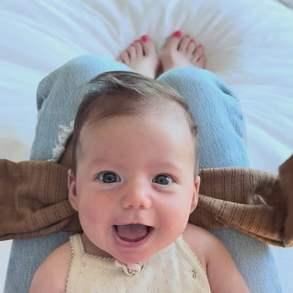 Tutorial video showing how to tie a mocha pointelle top knot bow.