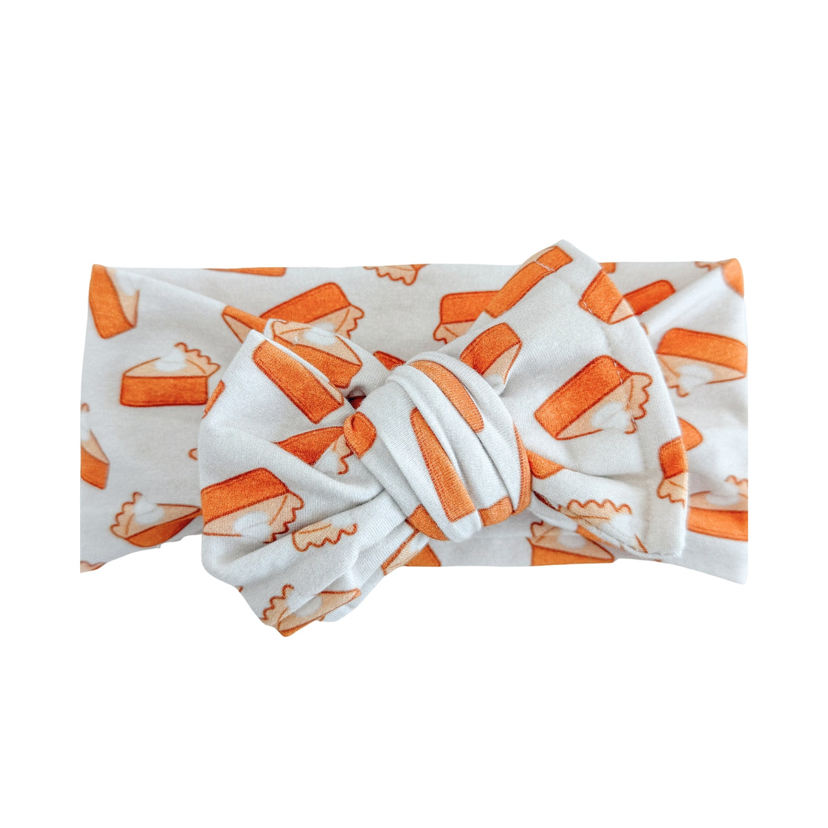 Oversized bow baby headband in taupe with orange pumpkin pie print, crafted from cotton jersey knit fabric, displayed on a white background