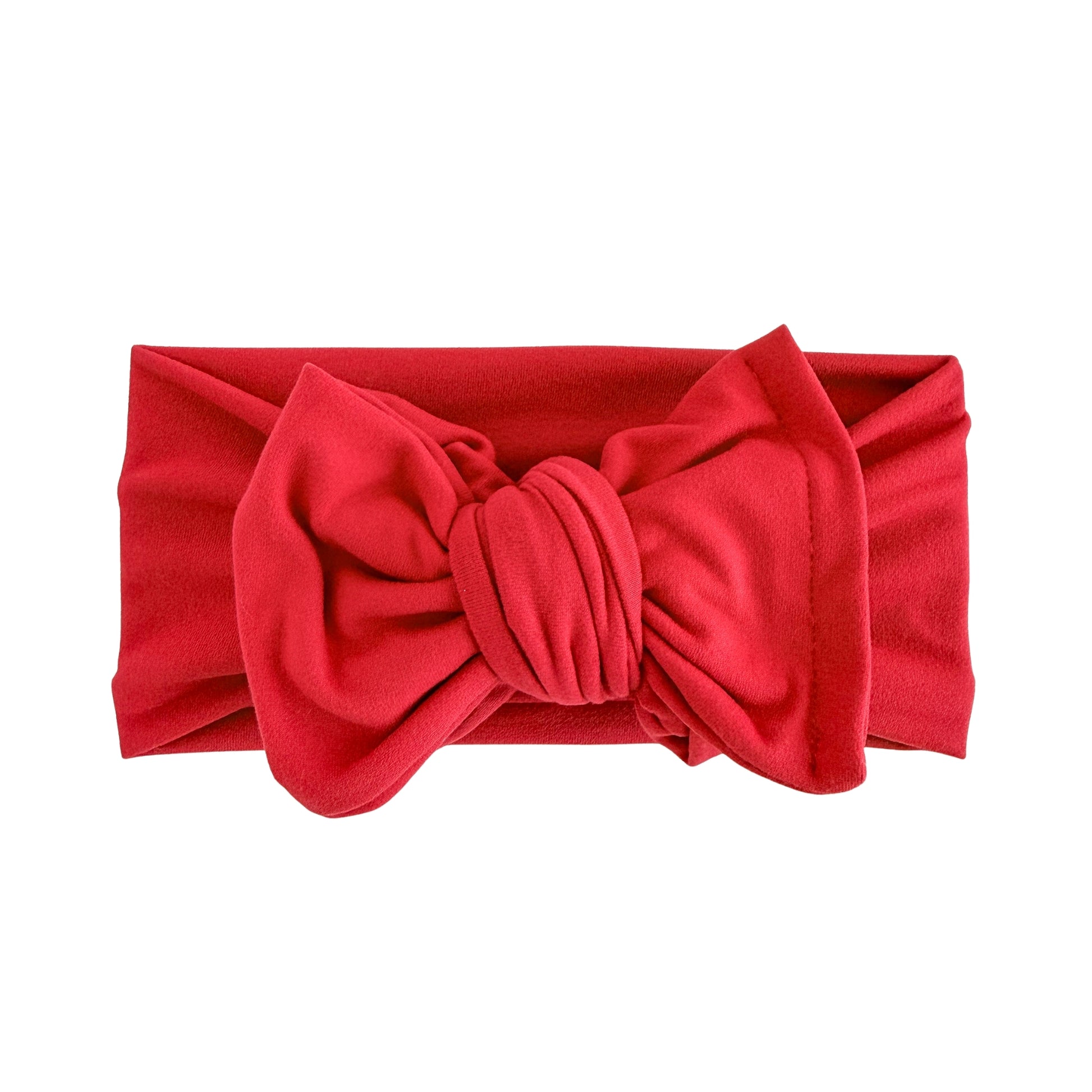 Oversized bow baby headband in red, crafted from double brushed knit fabric, displayed on a white background