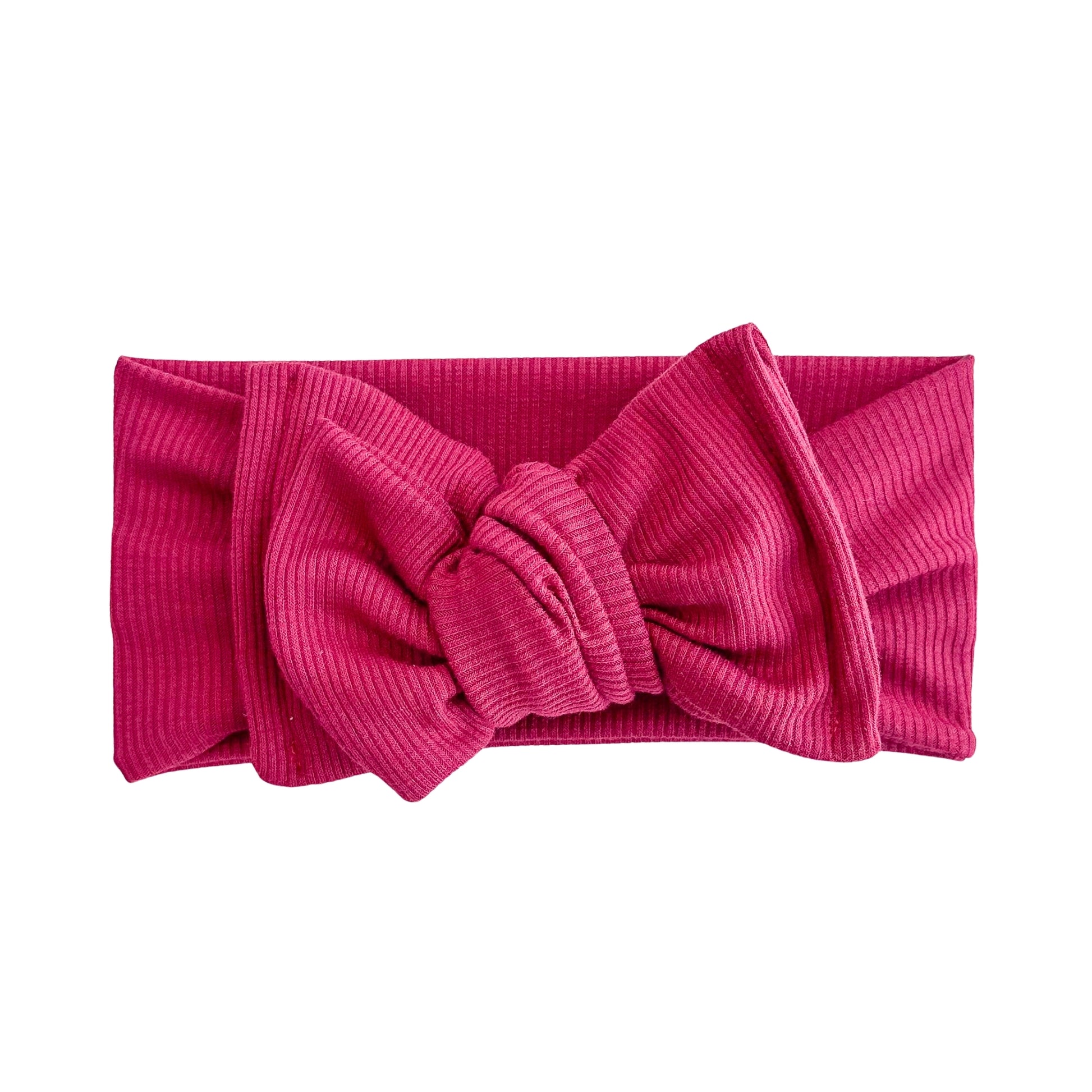 Top knot baby headband in red, crafted from ribbed knit fabric, displayed on a white background