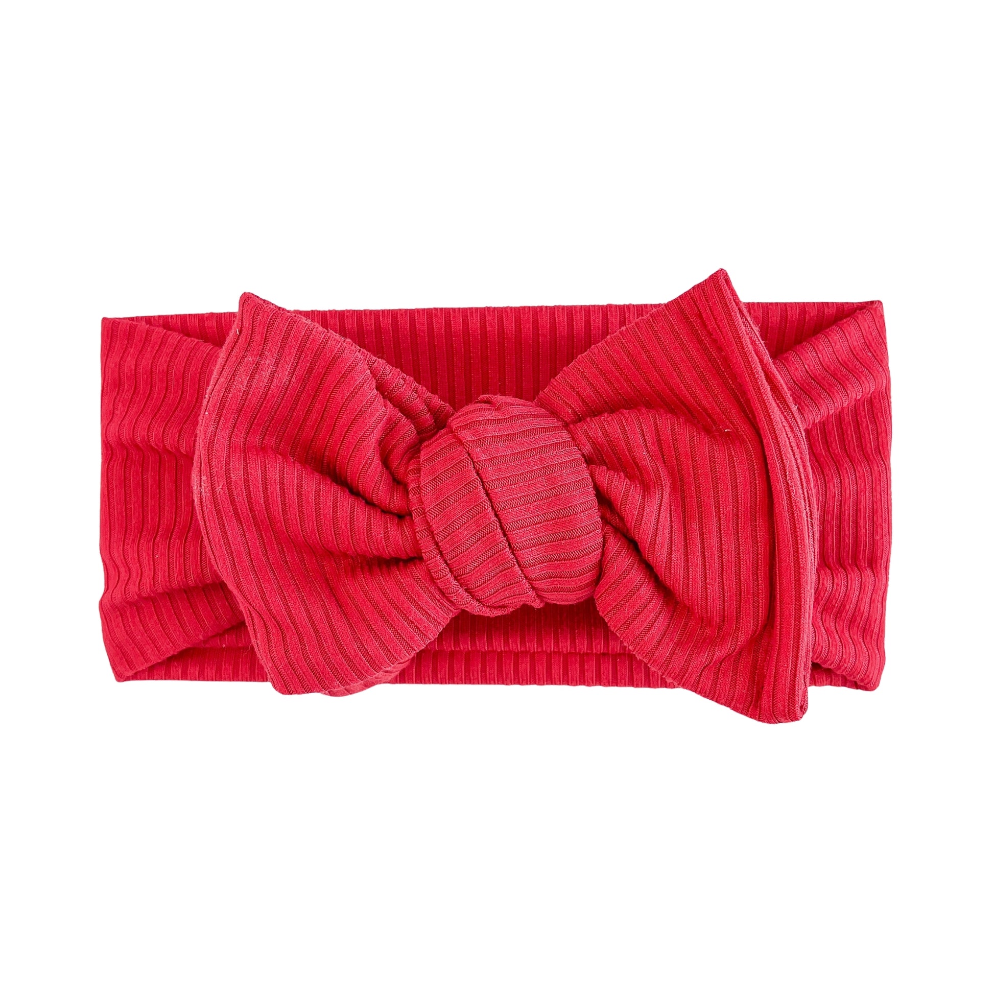 Oversized bow baby headband in red, crafted from ribbed knit fabric, displayed on a white background