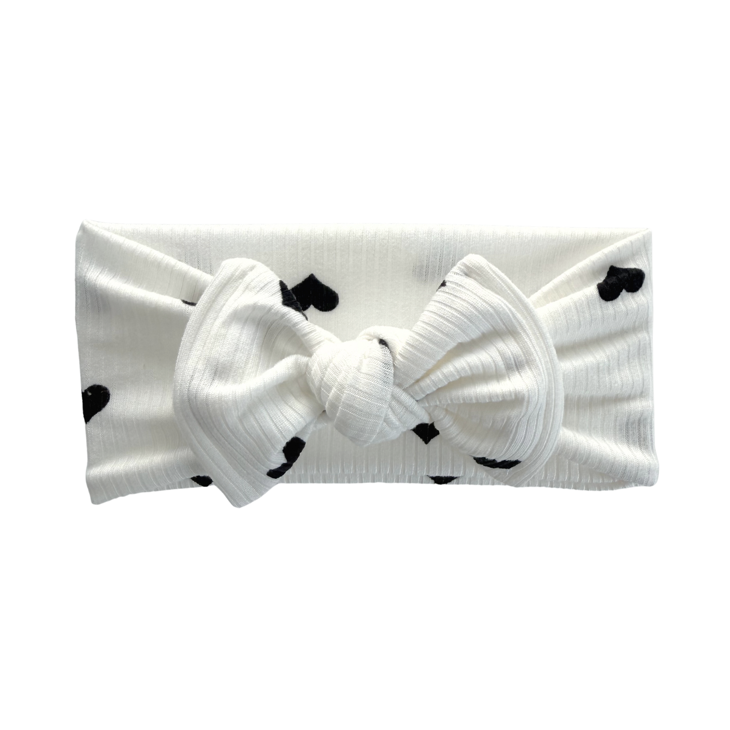 Ribbed white top knot baby bow headband with black heart print.