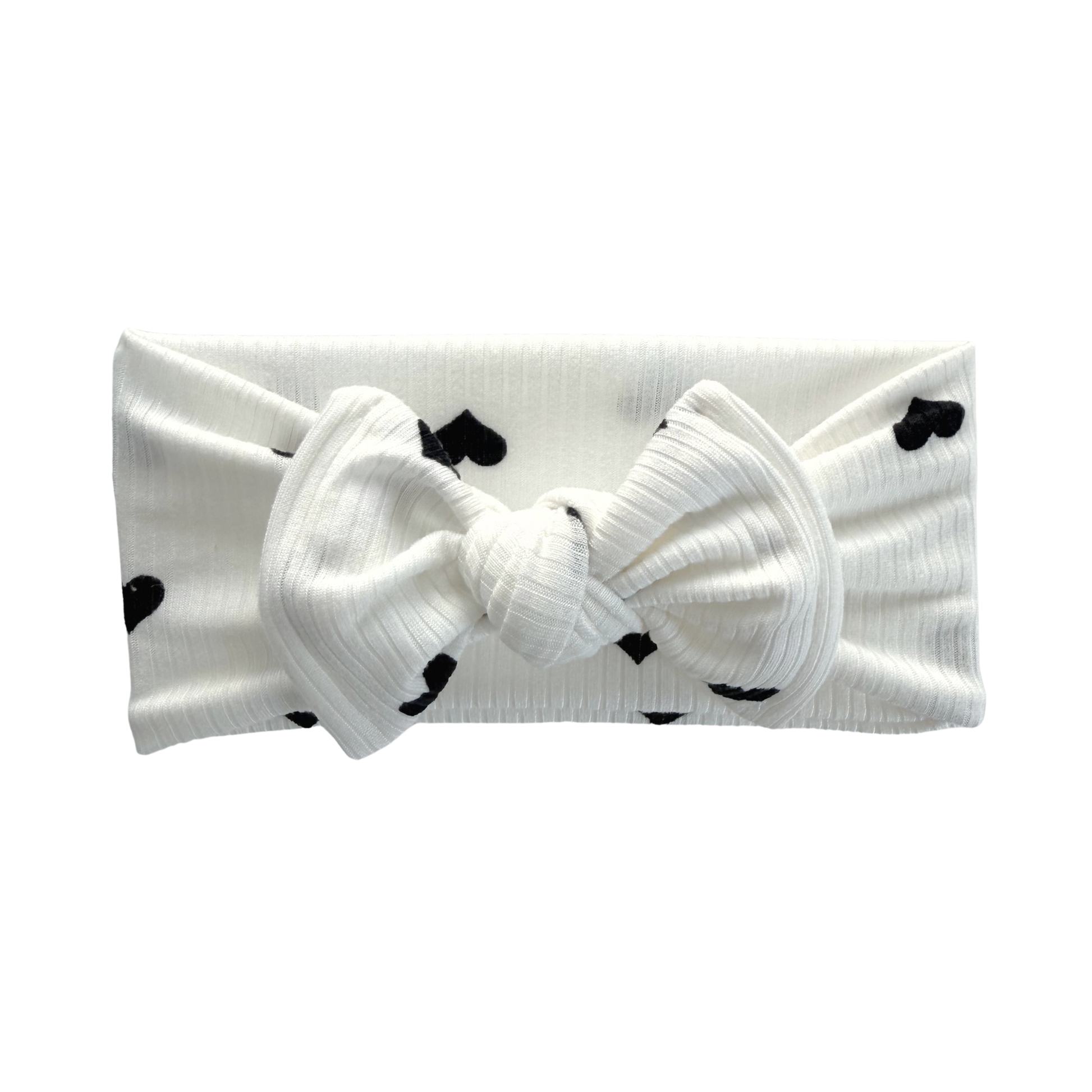 Ribbed white top knot baby bow headband with black heart print.