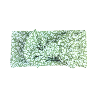 Green floral headband with a knot on a white background